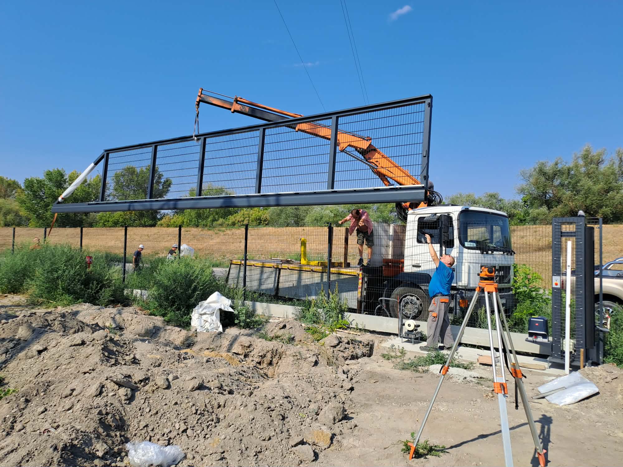 Montáž veľkej brány pomocou hydraulickej ruky